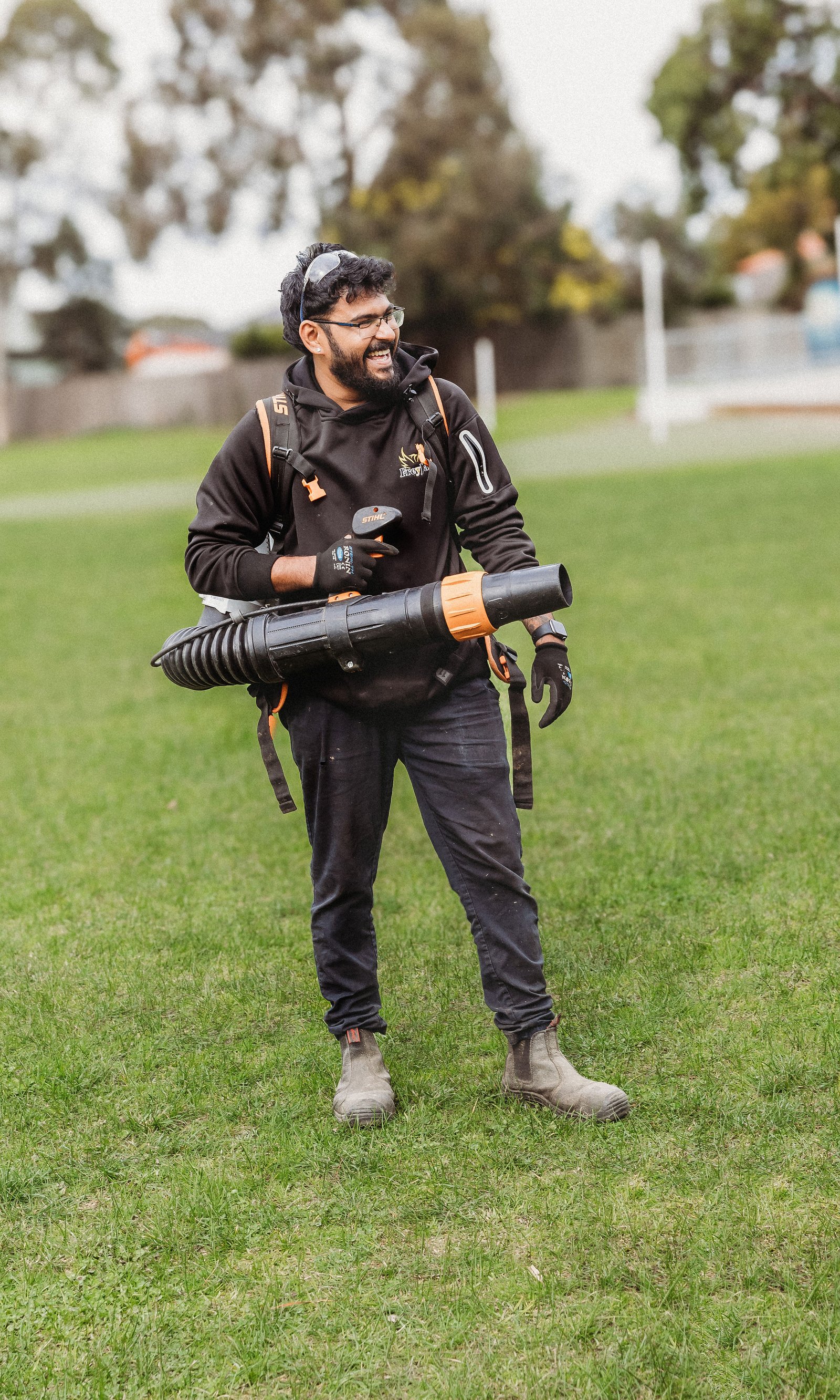 FreyJay Garden team using line trimmer on lawn Melbourne